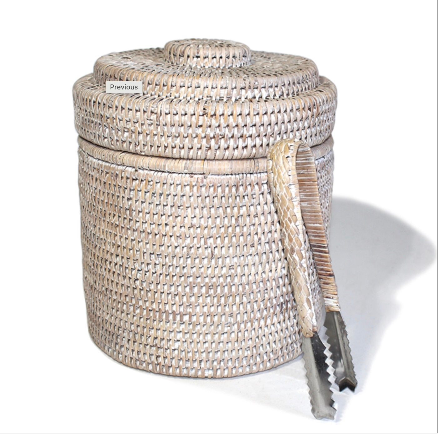 A beige round ice bucket liner with a thermos liner and ice tongs.