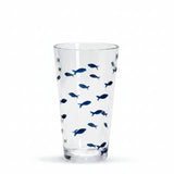 A clear drinking glass decorated with a pattern of small blue fish.