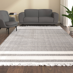 A rectangular area rug with a textured gray and white striped pattern.
