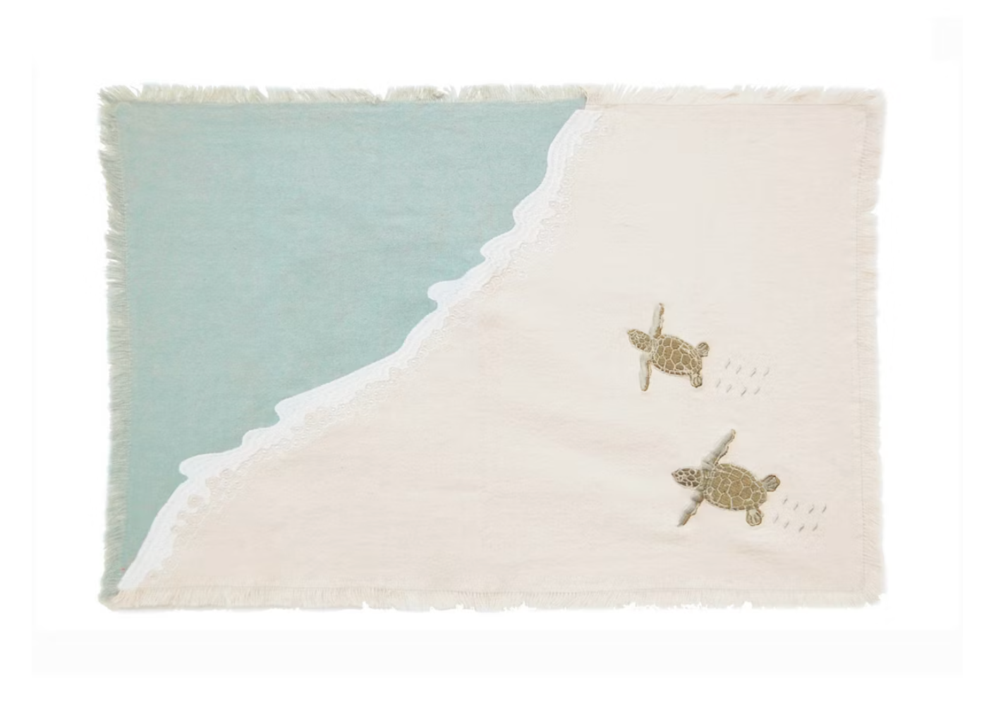 A rectangular woven textile with fringed edges, featuring a diagonal split between pale aqua and warm cream, with two small sea turtle motifs and dotted wave-like lines on the cream side.