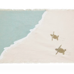 A rectangular woven textile with fringed edges, featuring a diagonal split between pale aqua and warm cream, with two small sea turtle motifs and dotted wave-like lines on the cream side.