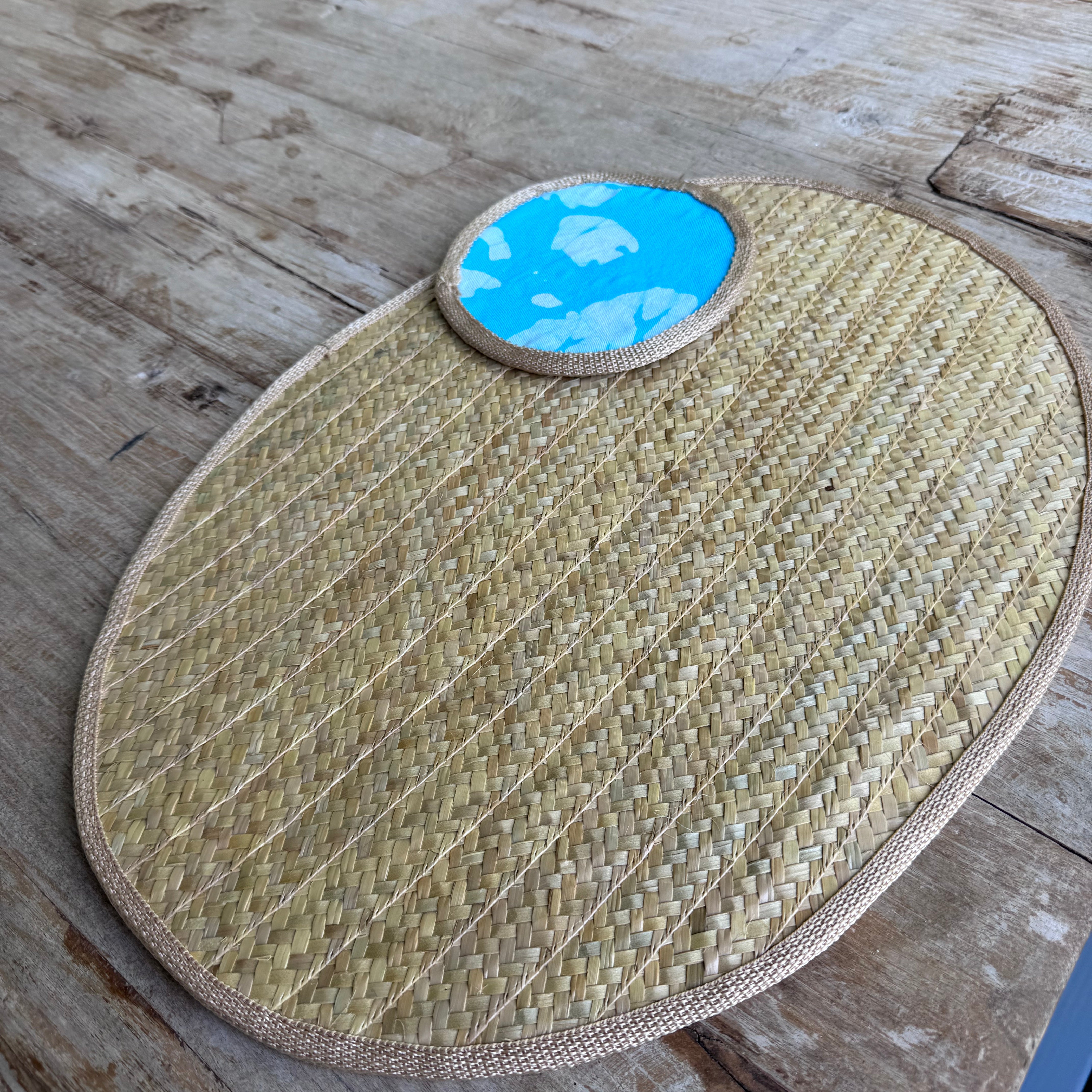 Woven mat with a blue circular coaster.
