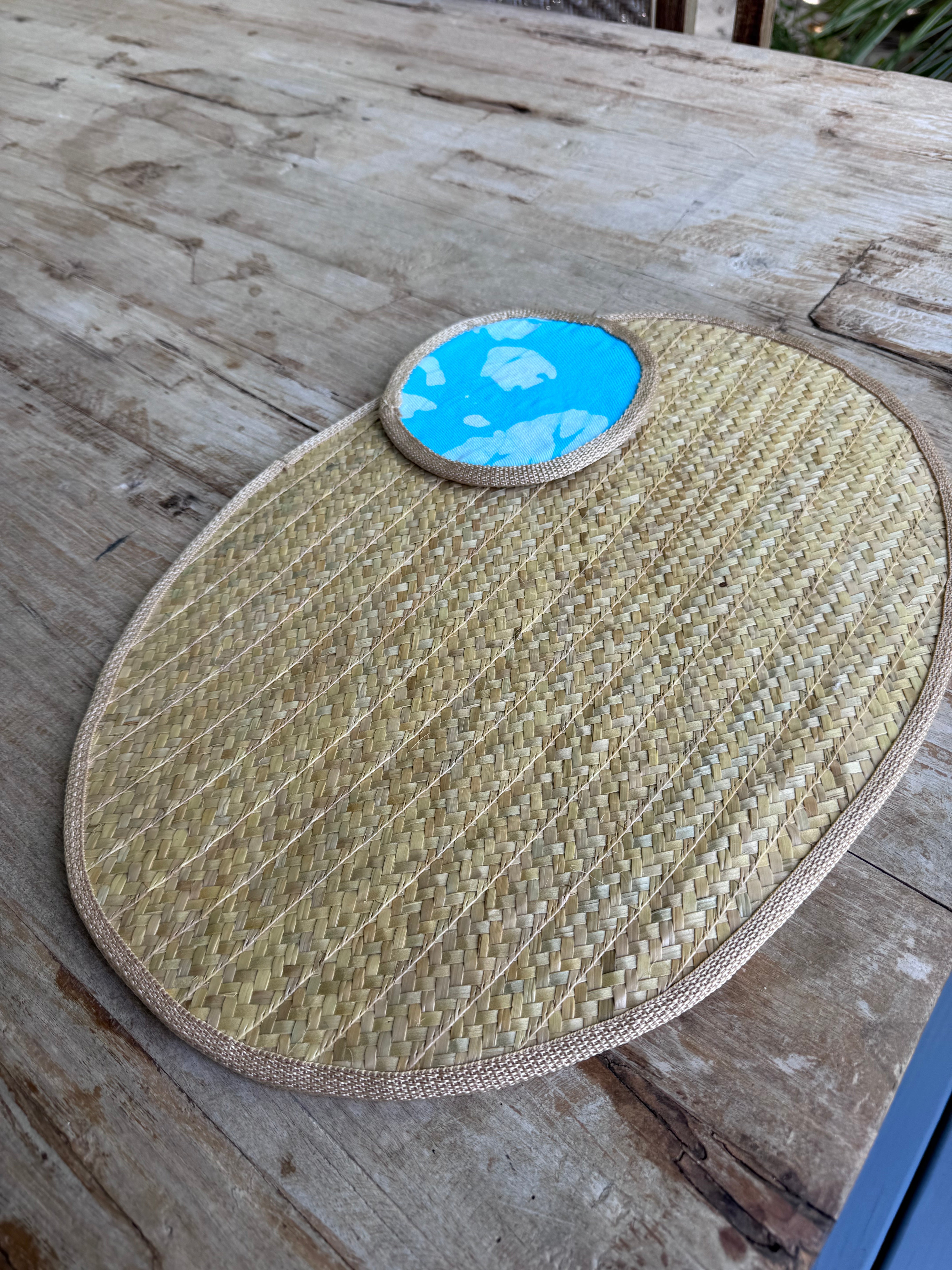 Woven mat with a blue circular coaster.