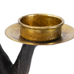 Brass candle holder with black base.