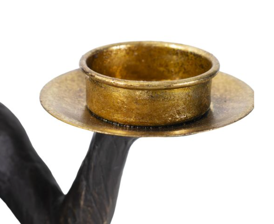 Brass candle holder with black base.