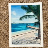 Painting of a tropical beach scene with a palm tree and a dock.