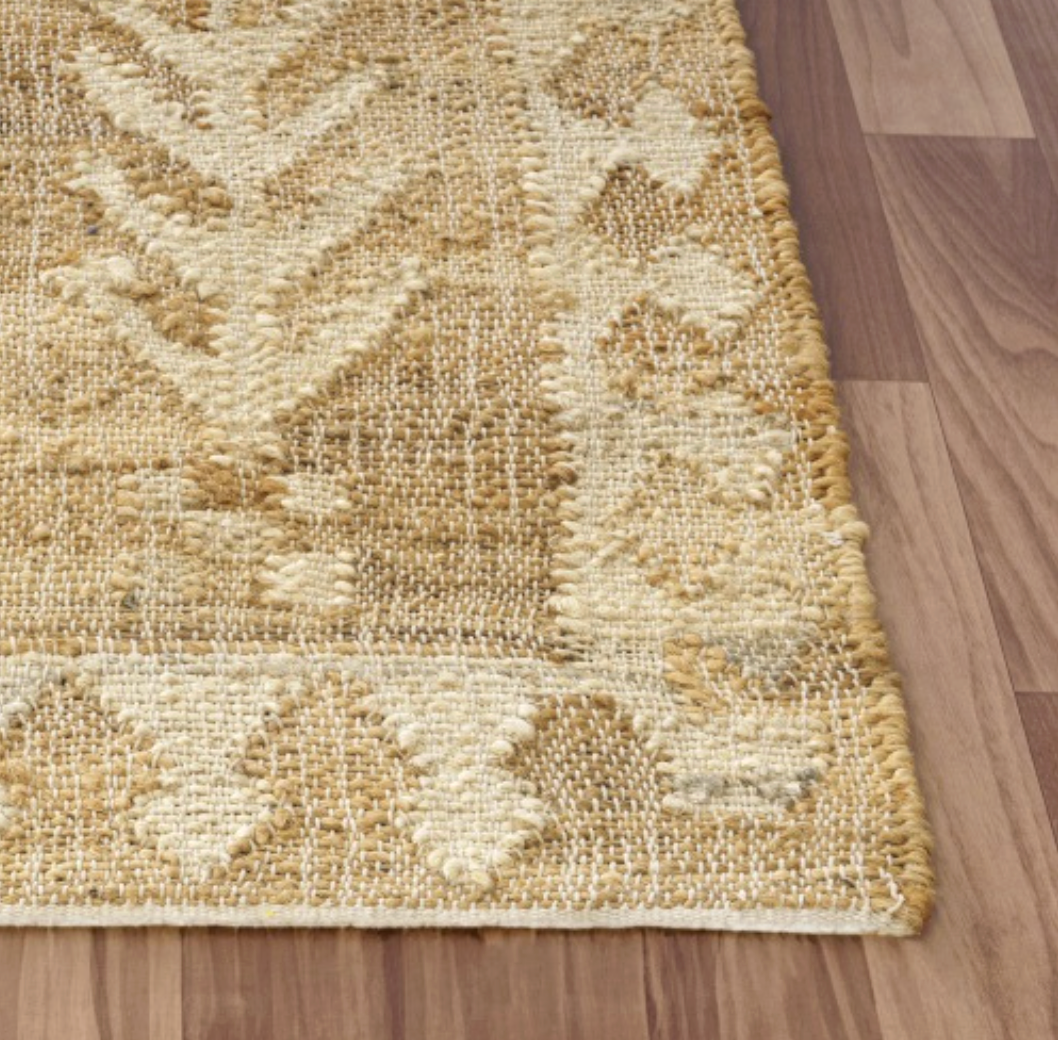 Textured beige rug .