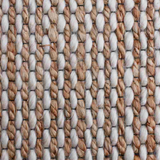 Close-up of a woven pattern with beige, brown, and white colors.