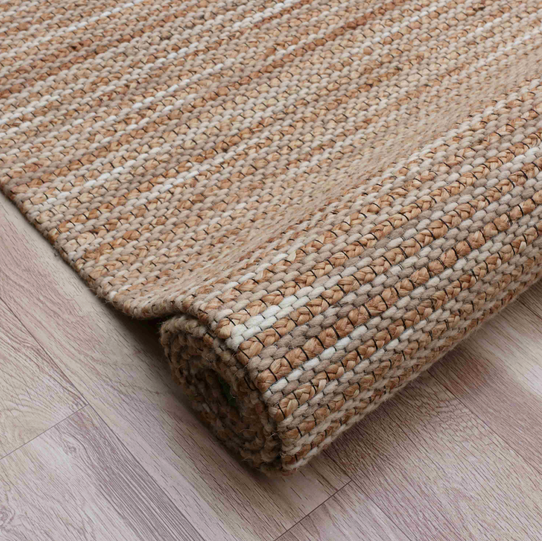 Rolled beige and white striped rug,