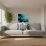 A rectangular throw pillow with vertical navy blue and white stripes and matching navy tassels on the sides.