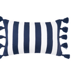 A rectangular throw pillow with vertical navy blue and white stripes and matching navy tassels on the sides,.