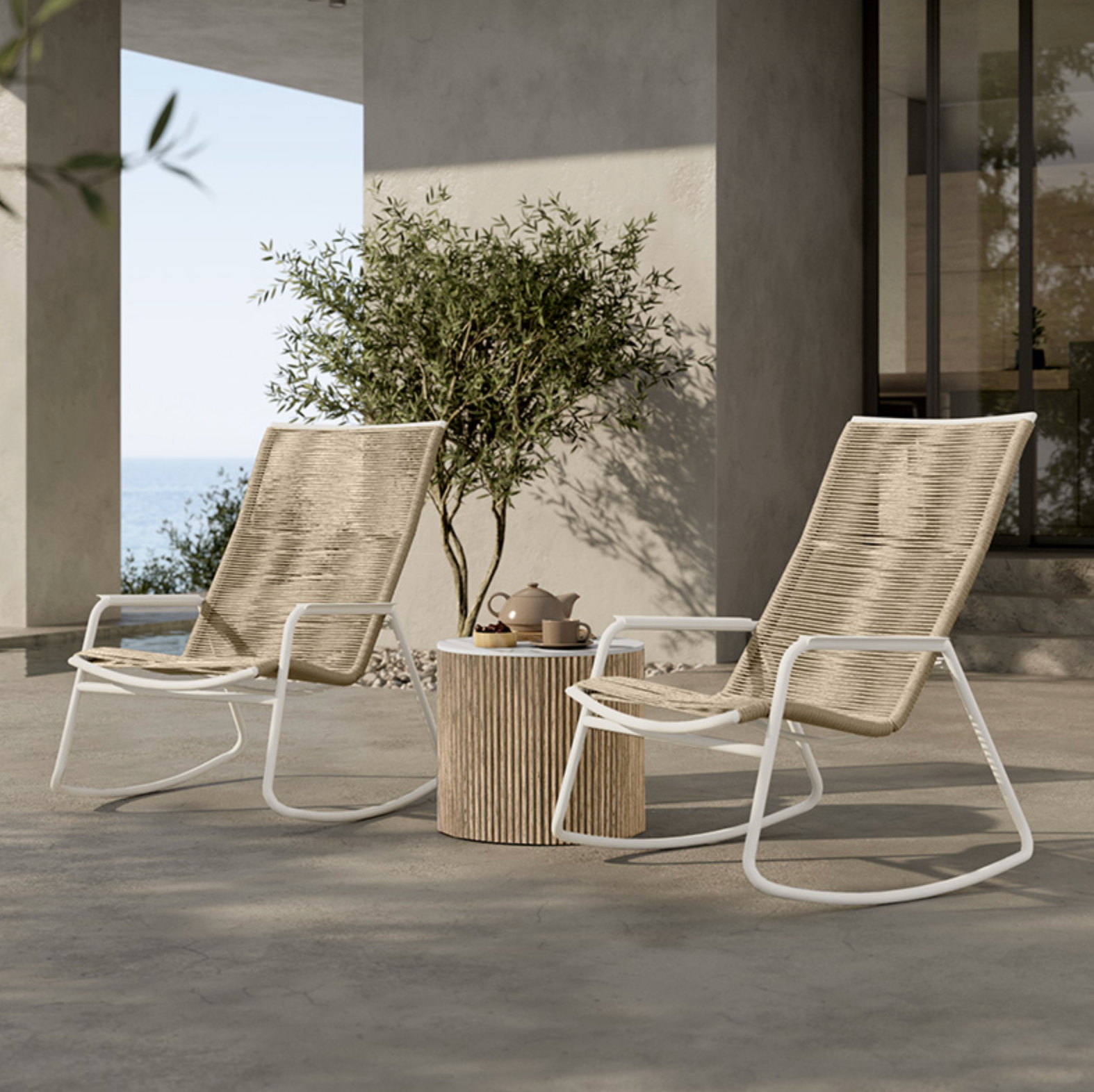 Two modern outdoor lounge chairs with woven beige sling fabric and white metal frames.