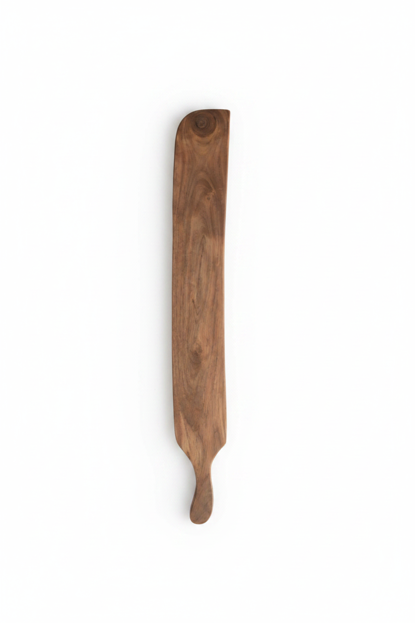 A long, narrow wooden serving board or paddle with a natural brown wood grain.