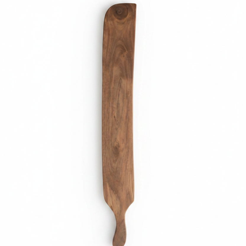 A long, narrow wooden serving board or paddle with a natural brown wood grain.