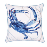 A square white throw pillow featuring a large embroidered blue crab design in the center, surrounded by subtle nautical rope and wave line details, finished with a light blue stitched border.