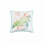 A square white throw pillow with a turquoise border, featuring a watercolor illustration of a green sea turtle swimming among coral.