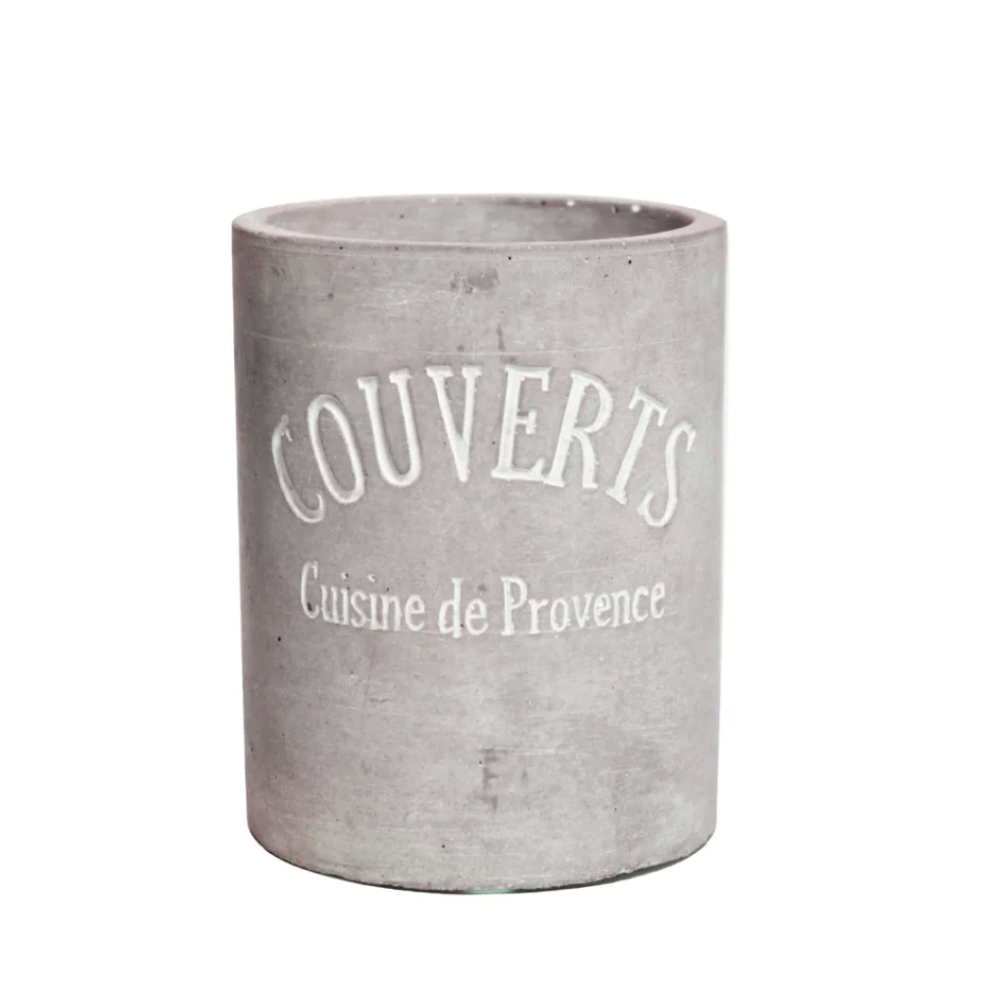 A cylindrical gray concrete planter with a distressed finish, featuring the words 'COUVERTS' and 'Cuisine de Provence' printed in white on the front.