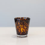 A tortoise print double old fashion glass with a heavyweight.