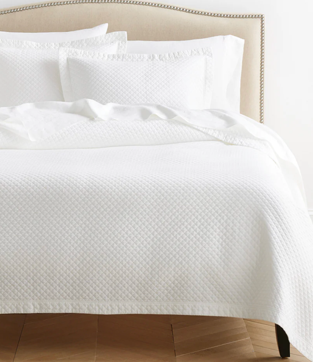 White textured quilt and pillow .