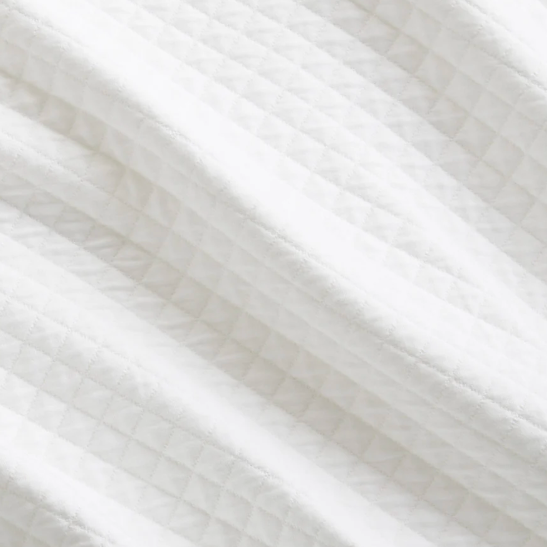 Close-up of white fabric with a subtle pattern