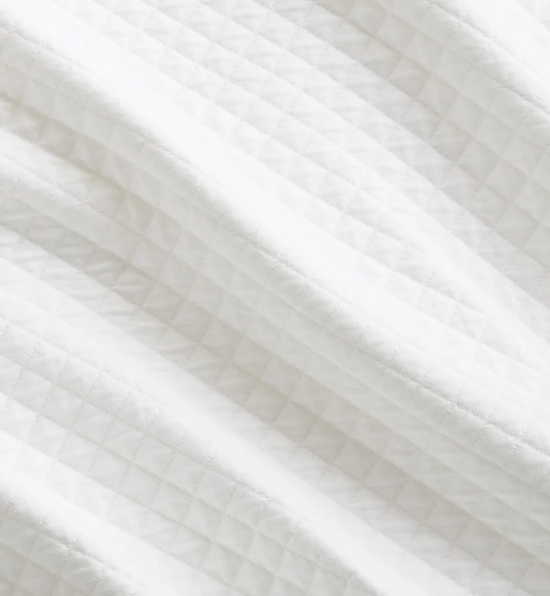 Close-up of white fabric with a subtle pattern