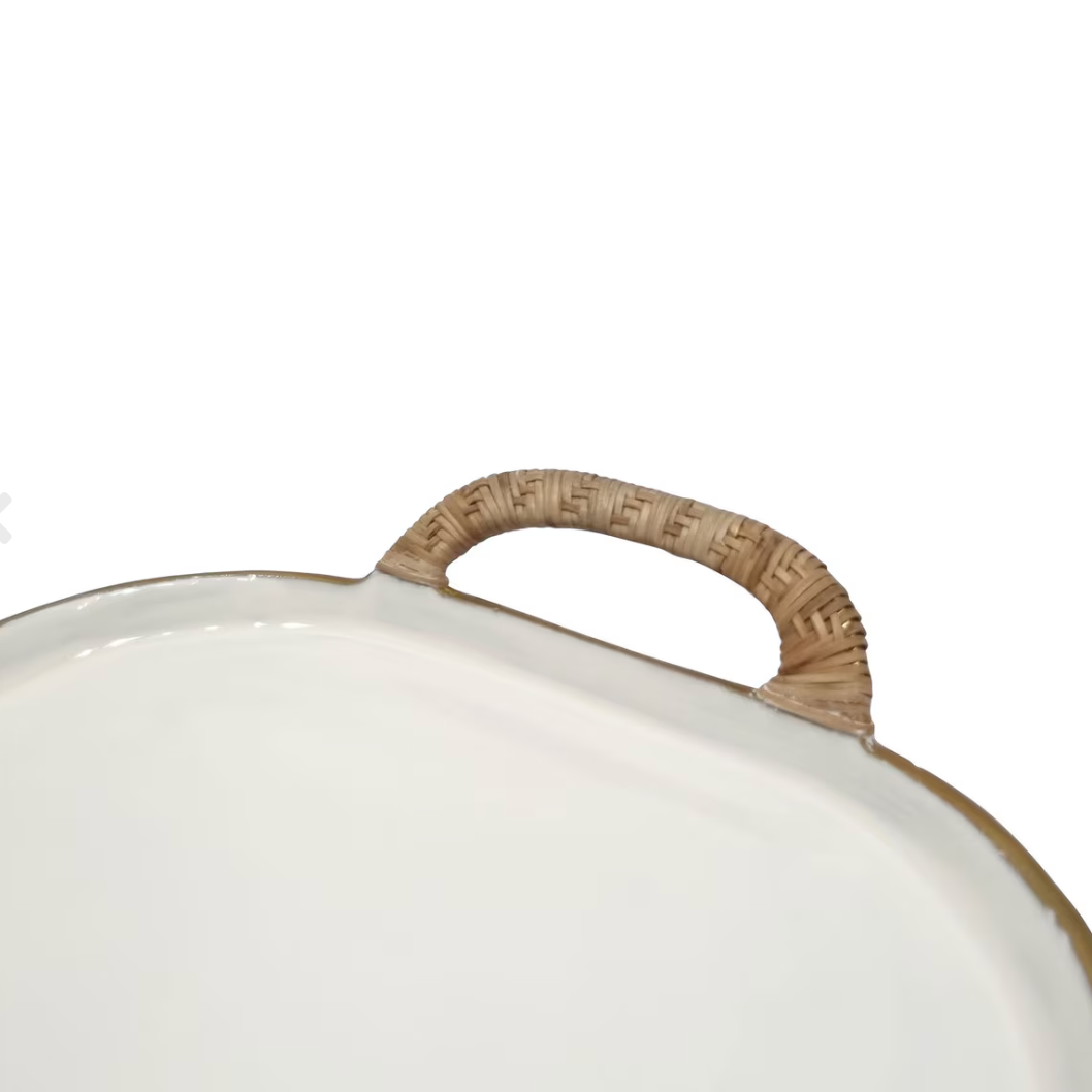 Close-up of a white oval tray or platter with a textured tan woven handle.