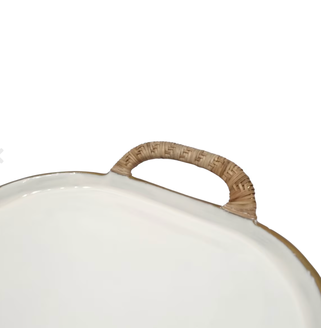 Close-up of a white oval tray or platter with a textured tan woven handle.