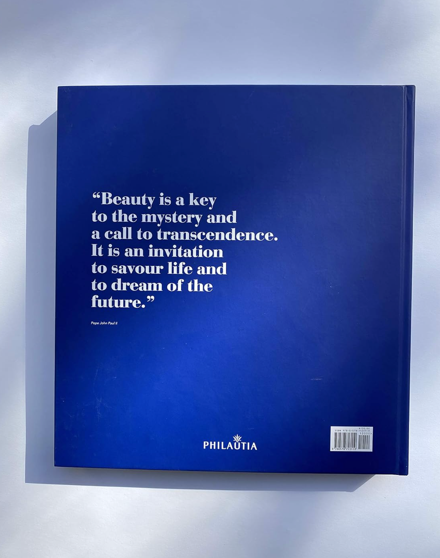 A hardcover book titled 'Beauty is a key to the mystery and a call to transcendence' by Paul Beaulieu, featuring a dark blue cover with white text.
