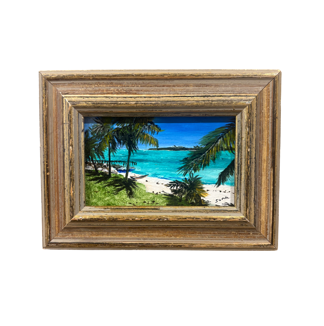 A framed tropical beach landscape painting featuring turquoise water, white sand, palm trees, and a blue sky, housed in a distressed brown wooden frame.