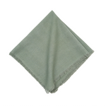 Soft sea glass napkins with delicate fringe detailing bring coastal elegance to your table. Each 22 x 22 inch napkin in this set of four offers generous coverage and versatile styling for everyday dining or special occasions. 