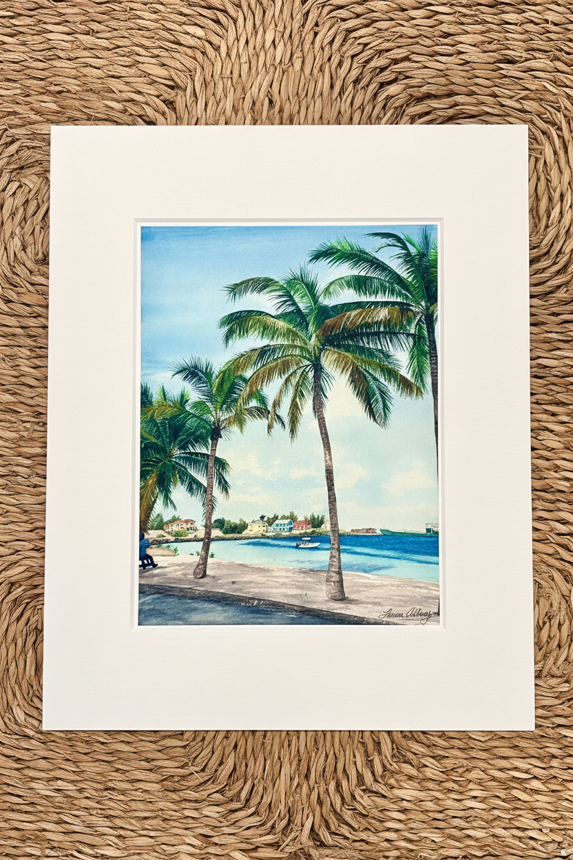 Art print of a tropical scene with palm trees and a beach.