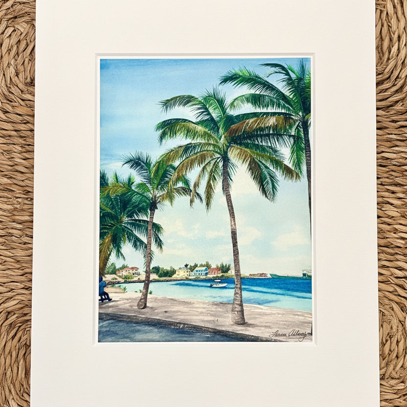 Art print of a tropical scene with palm trees and a beach.
