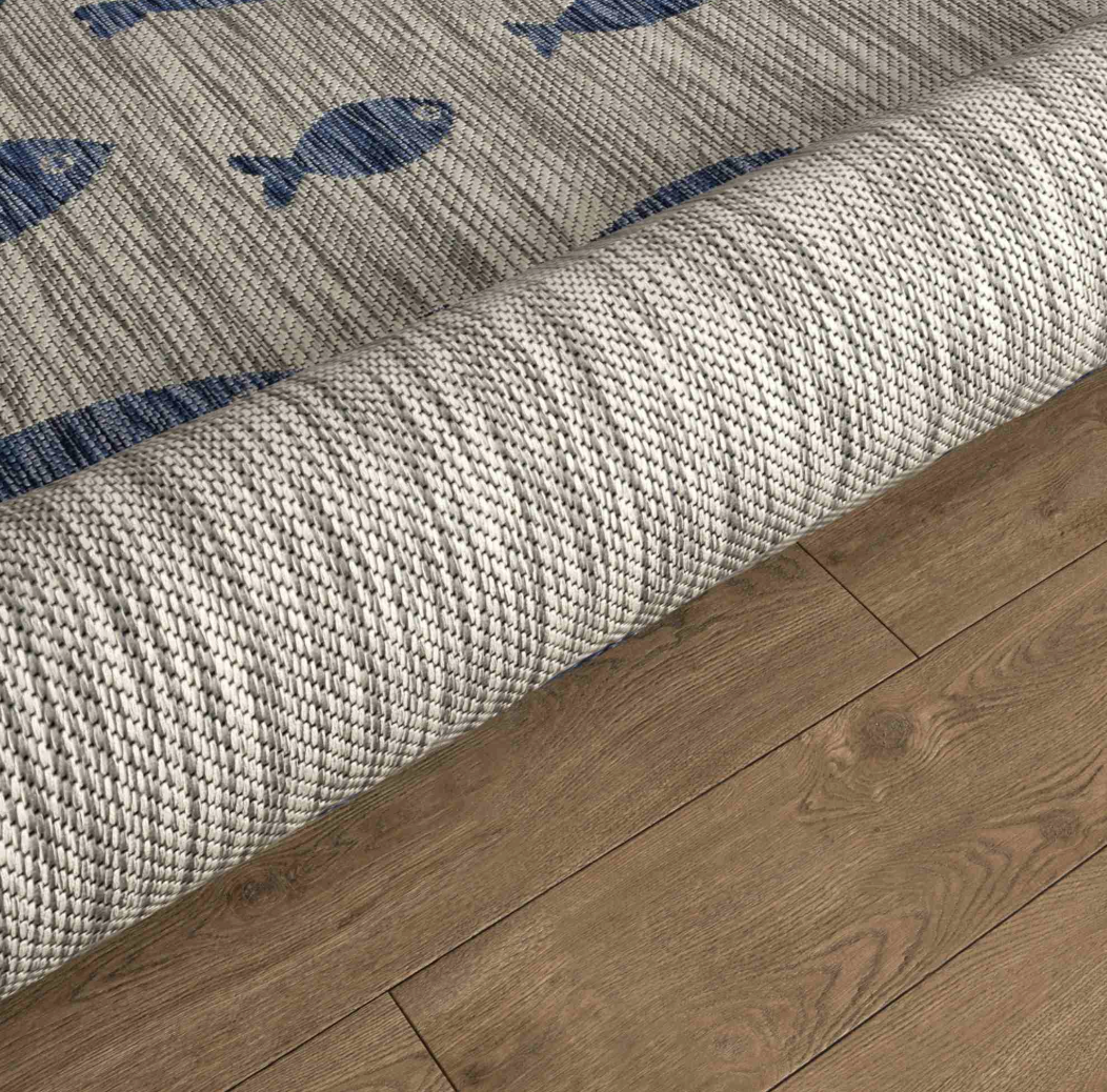 Textured rug with blue fish patterns.