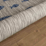 Textured rug with blue fish patterns.