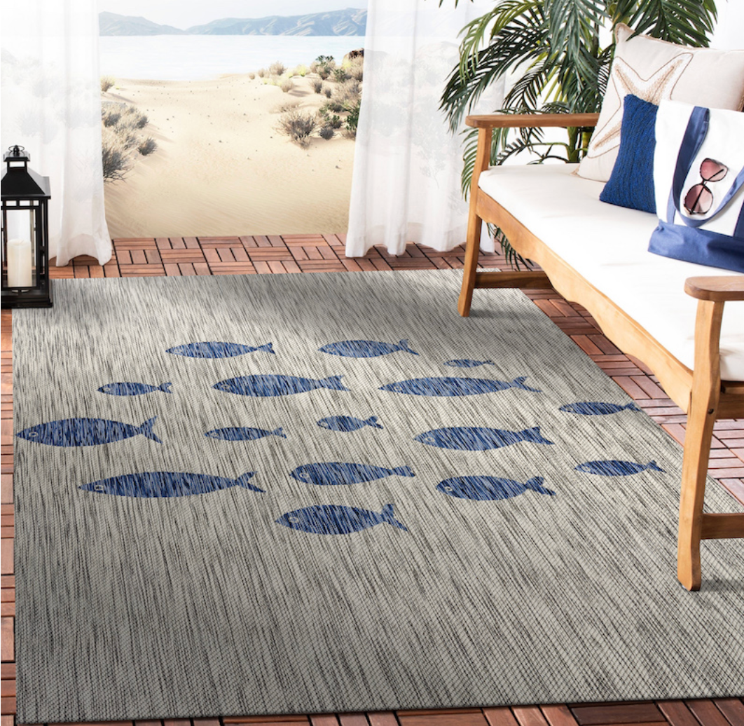 Gray indoor/outdoor rug with blue fish pattern.