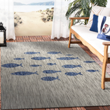 Gray indoor/outdoor rug with blue fish pattern.