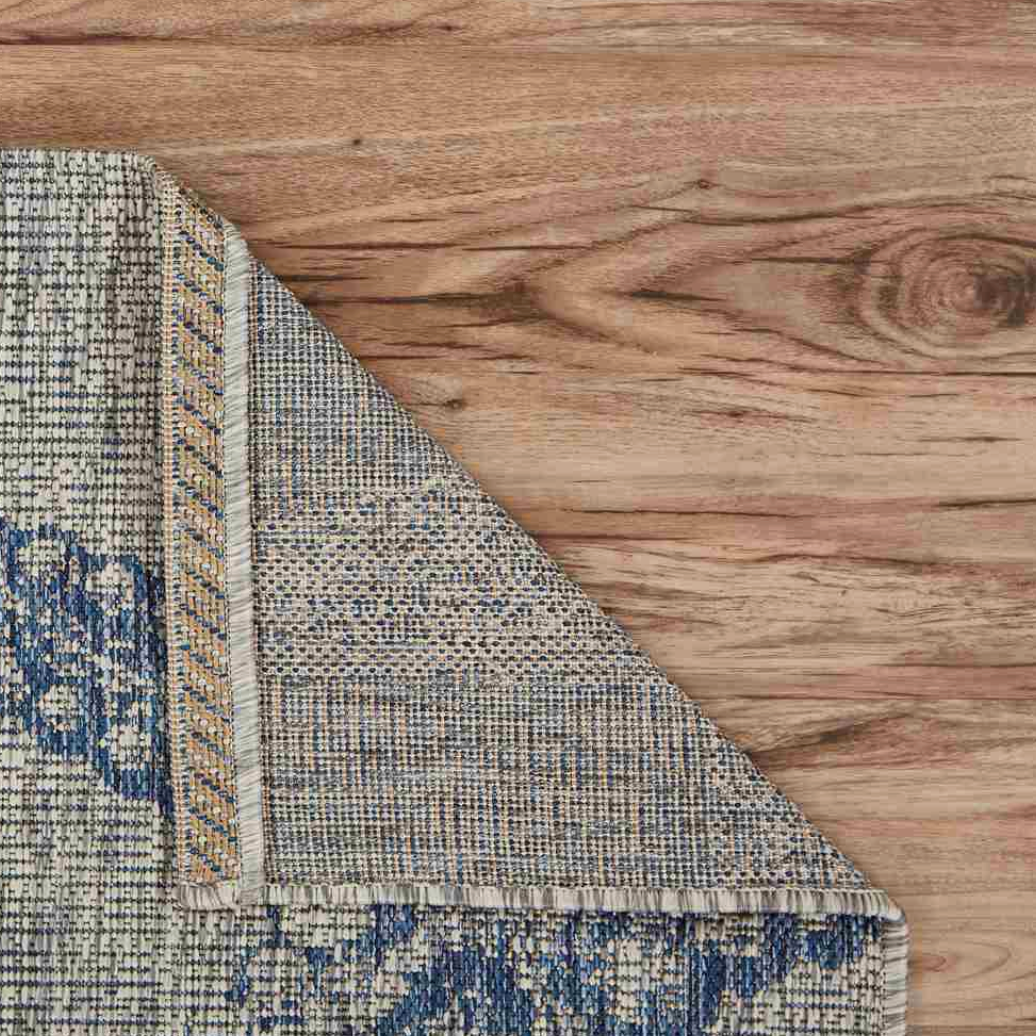 Corner of a patterned rug.