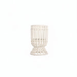 A white hurricane lamp with a woven design, featuring a removable glass insert.