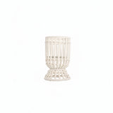 A white hurricane lamp with a woven design, featuring a removable glass insert.