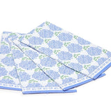 A stack of blue and white paper napkins with a floral pattern, including hydrangea flowers.