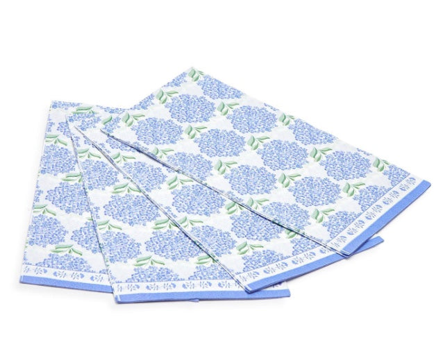 A stack of blue and white paper napkins with a floral pattern, including hydrangea flowers.