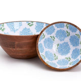 Two wooden bowls, one with a blue floral pattern.