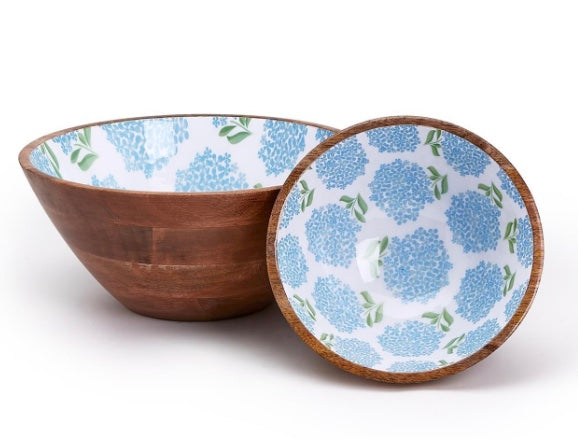 Two wooden bowls, one with a blue floral pattern.