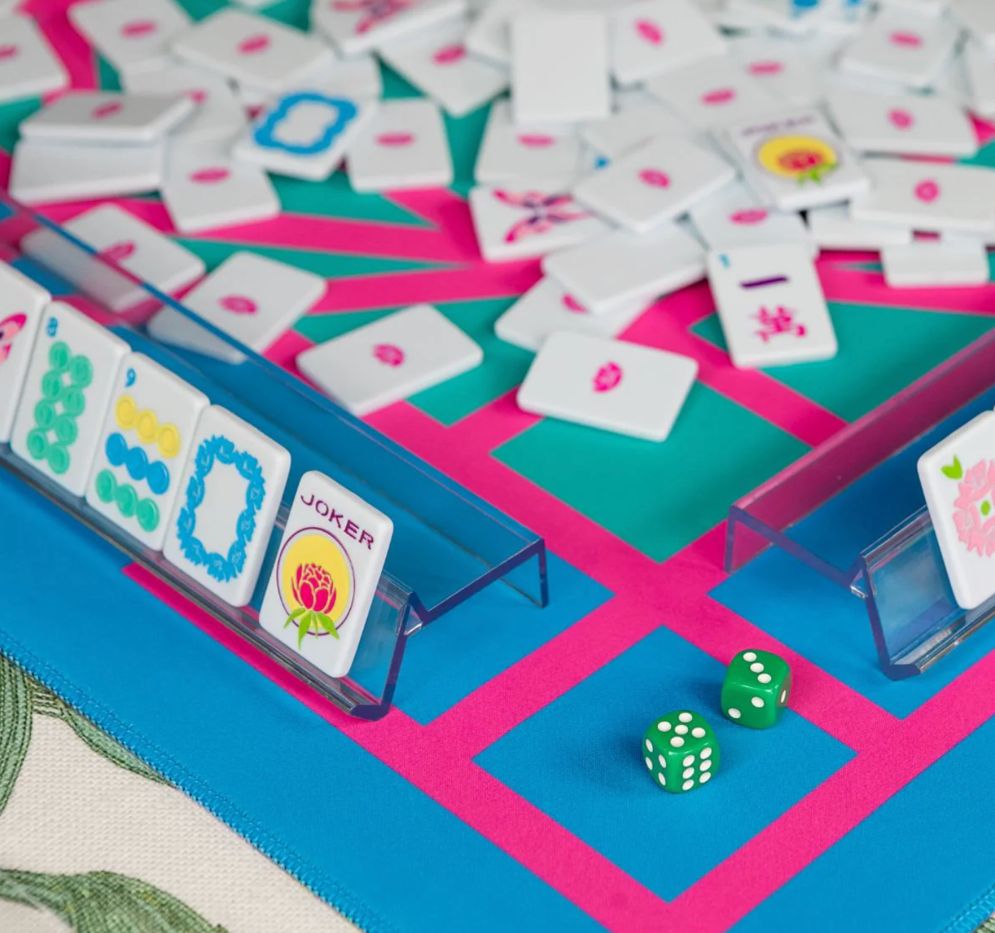 Close-up of a game board with tiles, dice, and card holders.