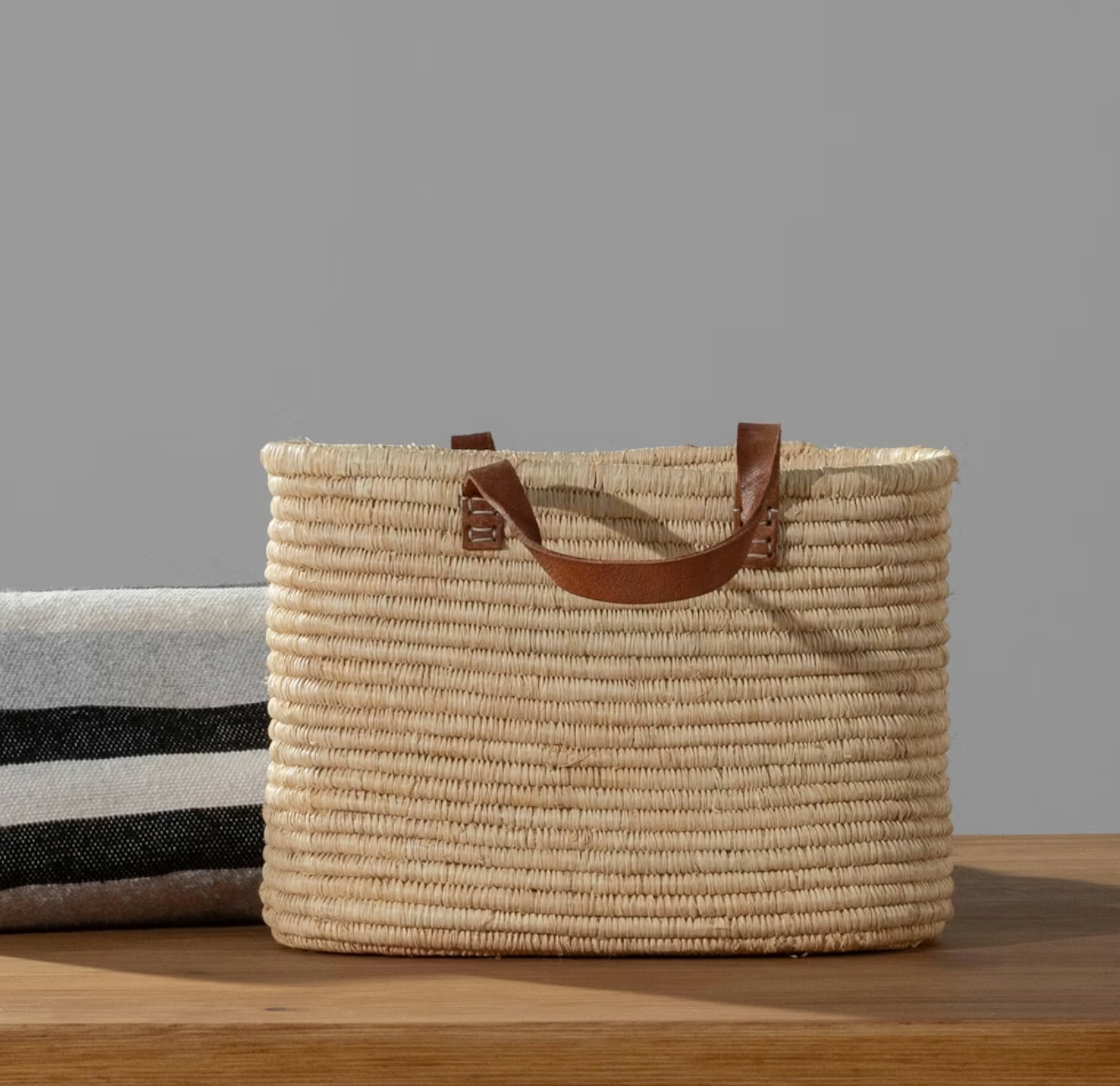Durable leather handles provide comfortable carrying for everyday storage and organization