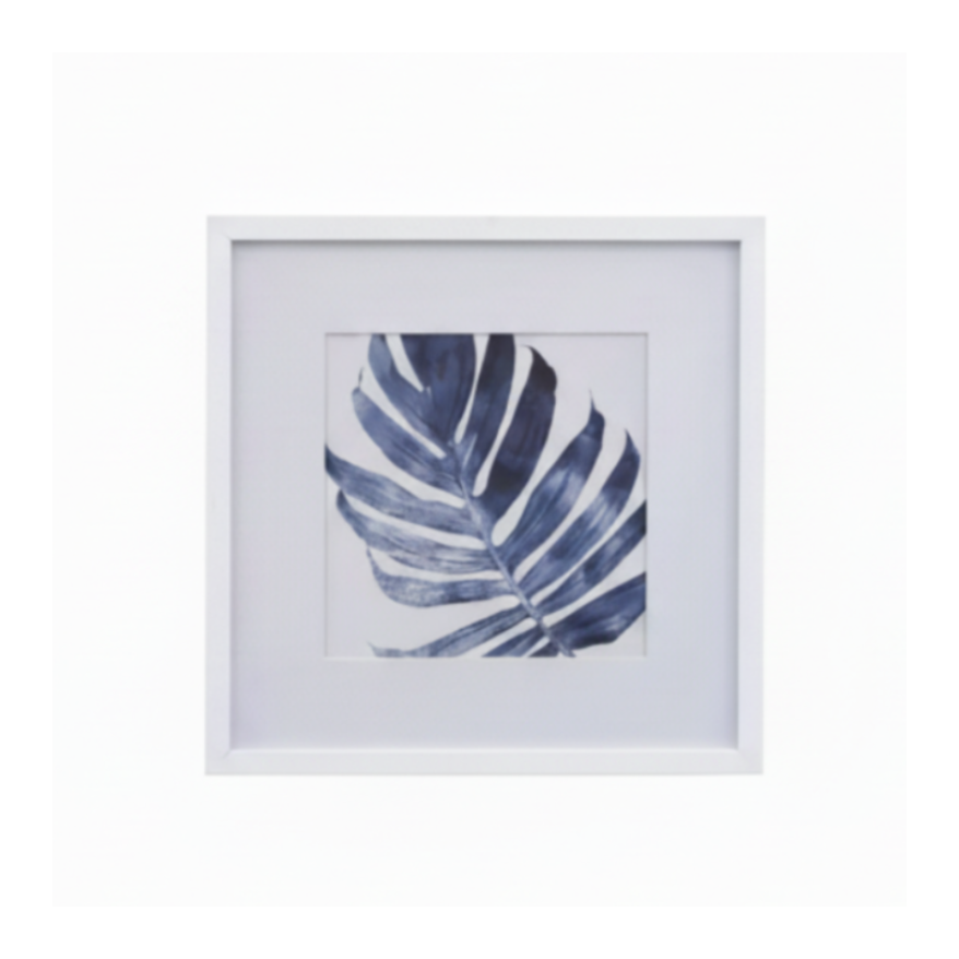 Framed botanical wall art featuring a single palm leaf print centered within a white mat and white frame.