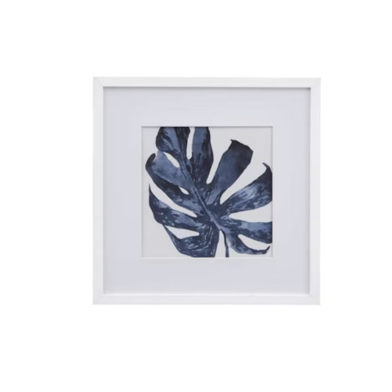Framed botanical wall art featuring a single large monstera leaf 