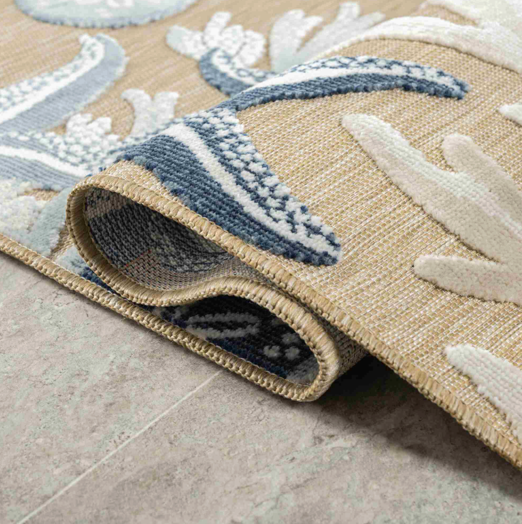 Close-up of a textured rug with coral patterns.