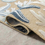 Close-up of a textured rug with coral patterns.