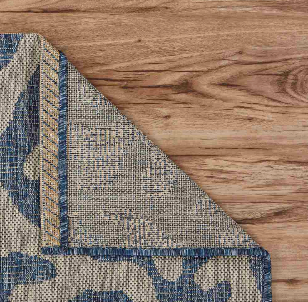 Corner of a patterned rug.